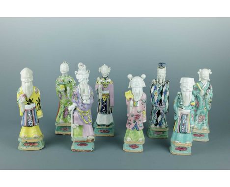 A set of Chinese Eight Daoist Immortals porcelain statuettes, 18th Century, Qianlong Period (1736-1795), each standing atop a