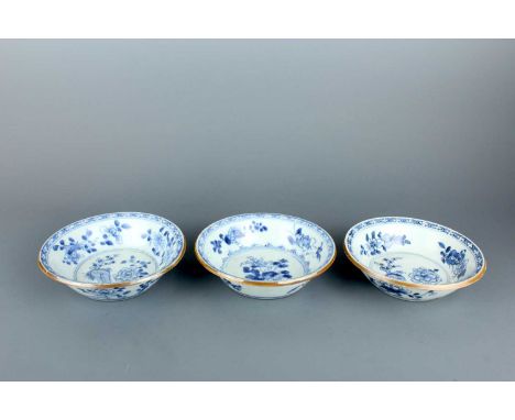 Three Chinese blue and white ‘floral’ shallow bowls, Qing Dynasty, Kangxi period (1662–1722). Each is heavily potted and pain
