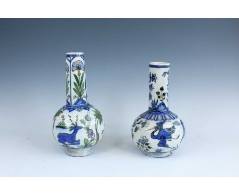 Two Persian pottery bottle vases, probably late 19th century. Each with a globular body rising to a long and straight neck, p