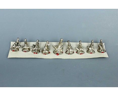 A set of Chinese ‘Eight Immortals’ silver ornaments with Shoulao, Qing Dynasty. Finely modelled with the nine deities each ho