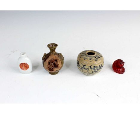 Four Chinese porcelain items, including a snuff bottle with an iron-red painted roundel, a small bottle vase with carved scen