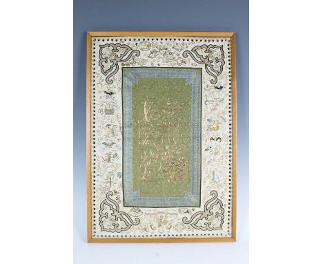 A Chinese framed embroidery panel, late 19th to early 20th century. Depicting trees and flowers in a rocky garden in the cent