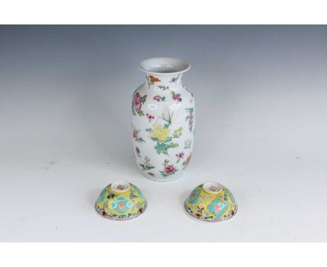 A Chinese famille rose vase and a pair of small bowls, 20th century. The vase is finely decorated with a variety of flowers, 