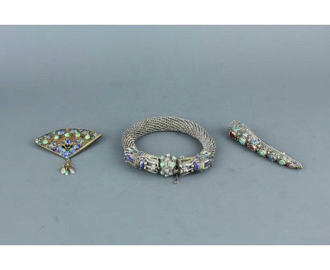 A Chinese white metal filigree ‘dragon’ bracelet with inlaid jewels, together with two other filigree pieces, 20th century. T