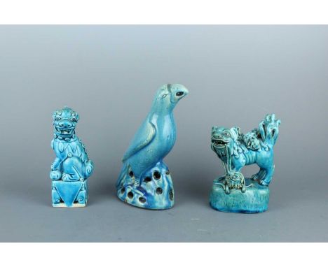 Three Chinese blue-glazed porcelain figures, Qing Dynasty, 18th-19th century. Comprising a Buddhist lion with cubs and a ribb
