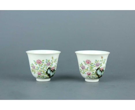 A pair of Chinese famille rose wine cups, early 20th century, each finely potted and exquisitely decorated with peony, orchar
