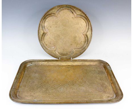 Two Persian brass serving trays, early 20th century, one of round form with a lobed rim, the other of rectangular shape with 