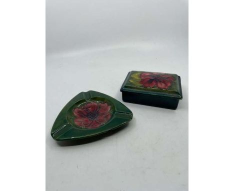 Moorcroft rectangular lidded box decorated with flowers on blue/green ground. Impressed Moorcroft mark to base and paper labe