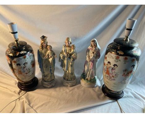 Two large Japanese style lamp bases on wooden stands, three religious figures, two marked Germany and a bisque headed doll.