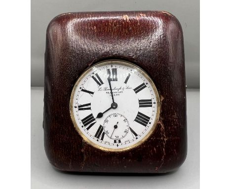 A leather cased pocket watch/travel clock by Barraclough. Winds and appears to run. White dial with Roman numerals and with s