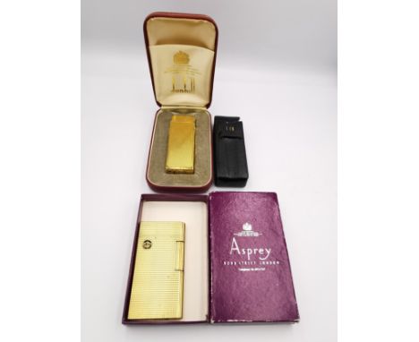 A collection vintage of gold plated lighters, including a cased gold plated Dunhill lighter with engine turned decoration and