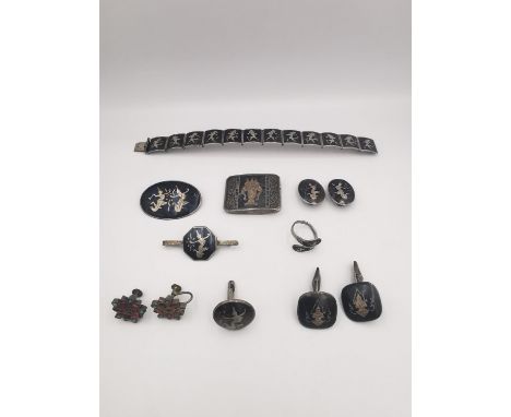 A collection of niello work Siamese silver jewellery , including a belt buckle, pair of clip earrings a tie bar, ring, articu