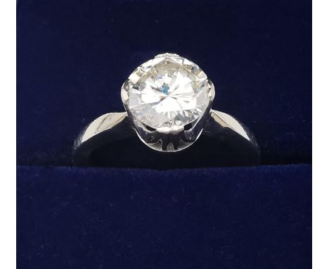 A boxed vintage white metal (tests as 14ct white gold) diamond solitaire ring, set with a round brilliant cut diamond, K/L co