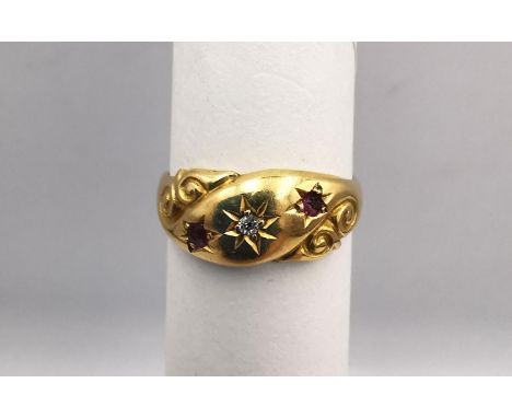 An antique 18ct yellow gold ruby and old mine diamond carved gypsy ring. Set with a round old mine diamond to the centre with