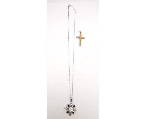 A 9ct yellow gold cross pendant with engine turned design along with a 9ct white gold cubic zirconia set stylised flower pend