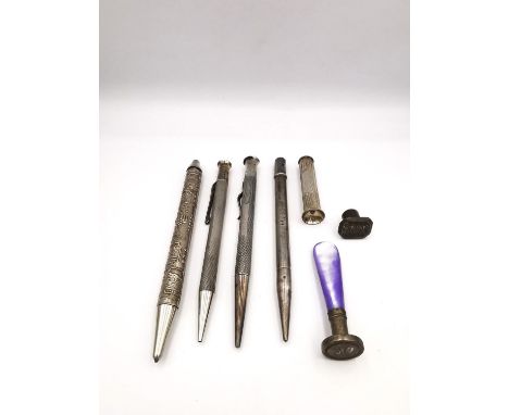 A collection of sterling silver ballpoint pens and pencils, seals and a silver cigar piercer. One ballpoint pen with relief i