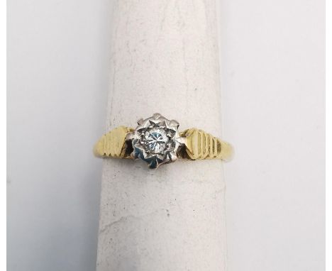 An 18ct yellow and white gold diamond solitaire ring. Set to centre with a round brilliant cut diamond in a star cut illusion