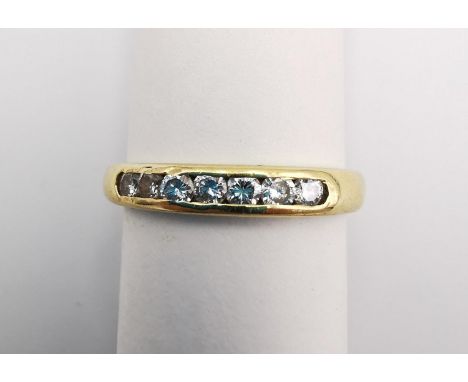 An 18ct yellow gold diamond seven stone half eternity style ring. Set with seven round brilliant cut diamonds in open back ch