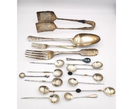 A collection of white metal and silver cutlery, including a pair of silver asparagus tongs, a Victorian silver serving fork a