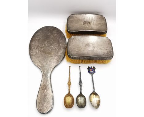 A collection of silver items, including an engine decorated brush set and hammered silver hand mirror, along with two silver 