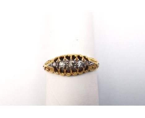 A carved 18ct yellow gold and diamond ring. Set with five round old cut diamonds with a combined approximate carat weight of 