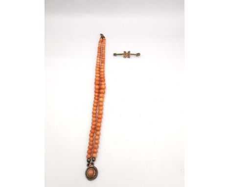 A Victorian double strand coral bead bracelet with yellow metal clasp (tongue damaged) along with a yellow metal and seed pea