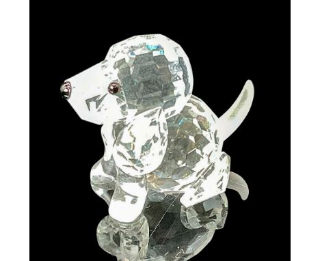 Crafted from faceted clear crystal, this adorable piece features a matte crystal tail, complemented by striking black eyes an