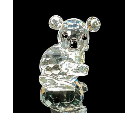 This adorable koala figurine is meticulously crafted from clear crystal, showcasing black eyes and nose for added charm. This