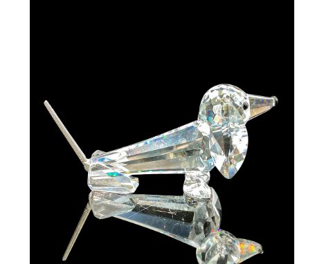 This crystal dachshund has a clear faceted body. waggy wire tail, with thoughtful black eyes and nose. This item has its orig