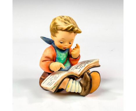 Matte porcelain, hand painted. Young boy wearing blue bib intently reading a storybook. Hummel impressed mark. Goebel backsta