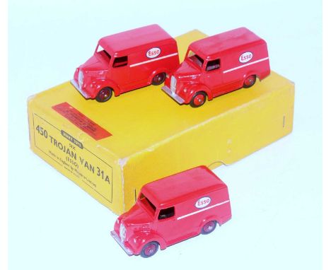 A Dinky Toys No. 31A Esso Trojan delivery van trade box containing three examples all finished in red with red/maroon hubs, b