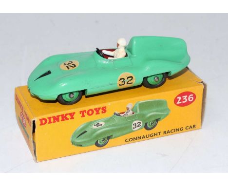 A Dinky Toys No. 236 Connaught Racing car comprising of light green body with green hubs, racing driver figure, and racing No