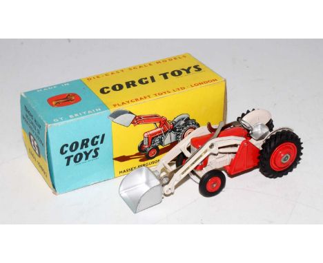A Corgi Toys No. 53 Massey Ferguson 65 tractor with shovel comprising of red and cream body with red metal hubs housed in the