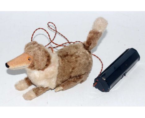 A Japanese tinplate and battery operated model of a standing and rising dog, covered in two-tone mohair with bark action and 