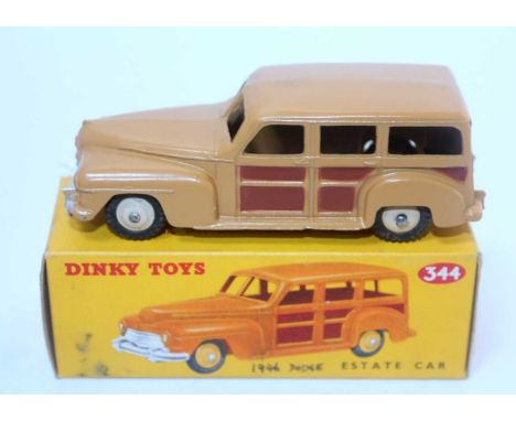 A Dinky Toys No. 344 Estate car comprising of two tone dark brown and light brown body with dark cream hubs housed in the ori