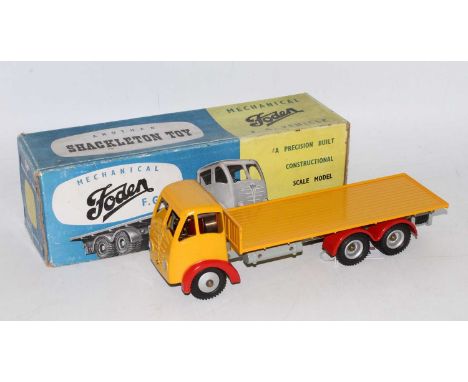 A Shackleton mechanical and clockwork Foden flatbed lorry finished in yellow with grey chassis and red mudguards, housed in t