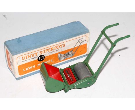 A Dinky Toys No. 751 lawnmower comprising red and green body with grass catcher, housed in the original orange and white labe