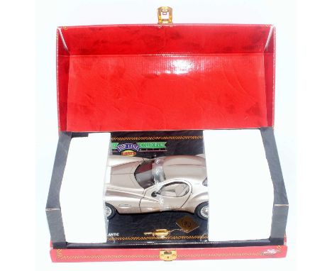A Guitoy Ref. No. 68570 1/18 scale model of a Chrysler Atlantic finished in silver, housed in the original fall front lockabl