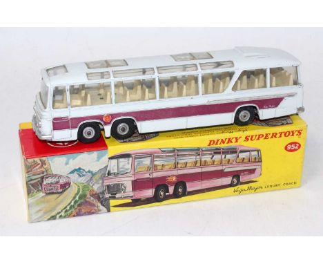 A Dinky Toys No. 952 Vega Major Luxury Coach comprising of off-white body with light yellow interior, purple and silver side 