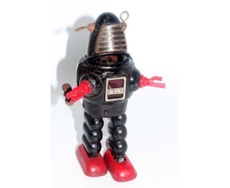 A KO of Japan tinplate and clockwork Planet Robbie the Robot comprising of black body with red feet, red plastic arms and fix