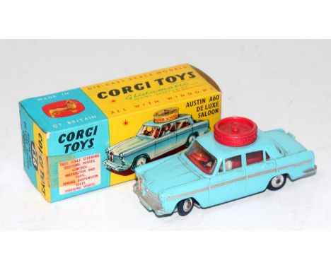 A Corgi Toys No. 236 Motor School Car comprising of light blue body with working steering mechanism, driver and passenger fit