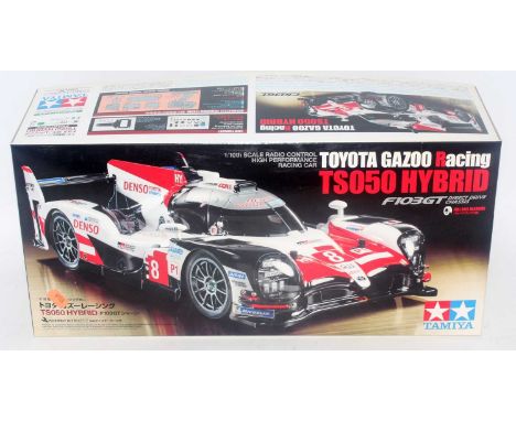 A Tamiya model No. 58665 1/10 scale radio controlled assembly kit for a Toyota Gazoo Racing TS050 hybrid race car, appears as