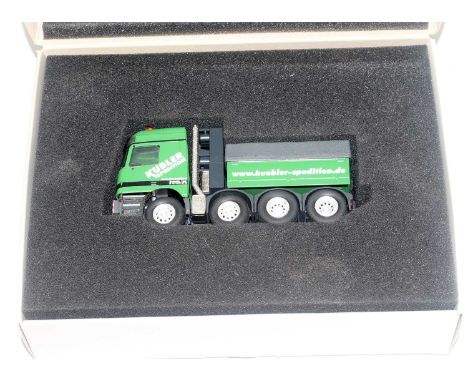 A Conrad model No. 40002 1/50 scale model of a Mercedes Benz Actross SLT tractor unit, comprising of green and grey body with