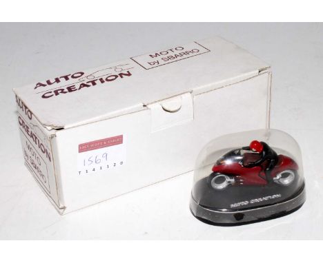 An Auto Creation 1/43 scale model of a Sbarro motorcycle and driver, housed in the original snow globe style display box