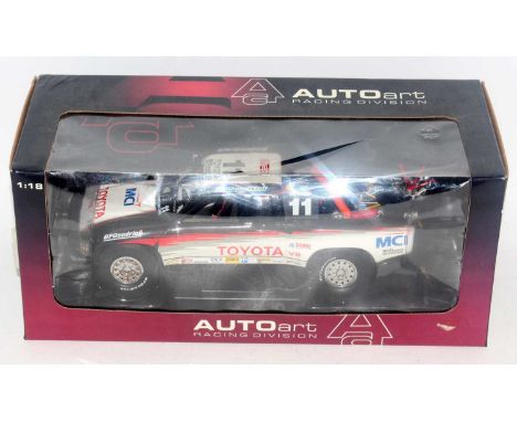 An Auto Art model No. 80010 1/18 scale model of a Toyota Trophy Truck, finished in black, white with red and grey side flashe