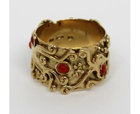 A 9ct gold ladies' dress ring with abstract decoration and cabochon-set corals, size M, approx 7.3g.