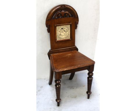 A late 19th/early 20th century oak hall chair, curved top above foliate carving with Minton Shakespeare Series black and whit
