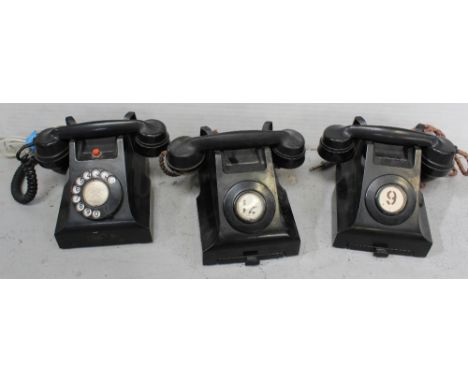 Three vintage black Bakelite GPO telephones, two with notepad drawers and no number dials, marked 332CB and one other example