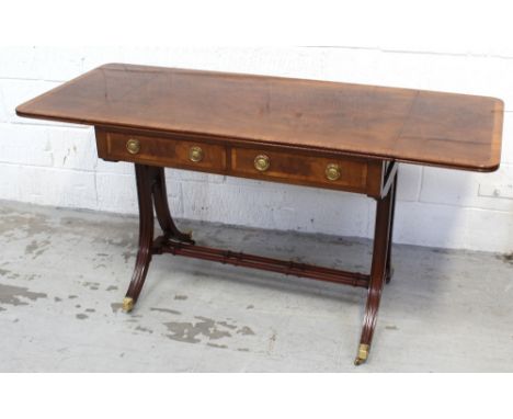 A reproduction mahogany sofa table with satinwood cross-banding, two frieze drawers to one side, blind drawers to the other, 