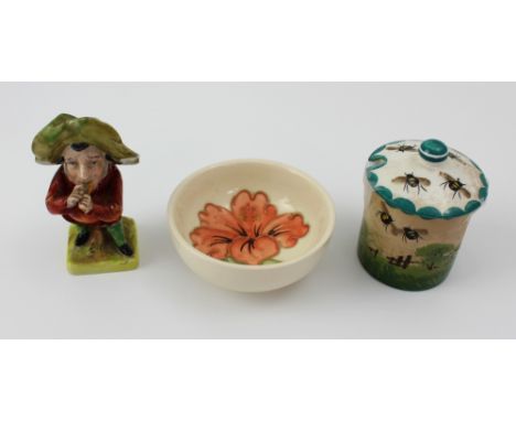 A Wemyss preserve pot, a small Moorcroft hibiscus design pin dish and a miniature Mansion House dwarf figurine, blue marks to